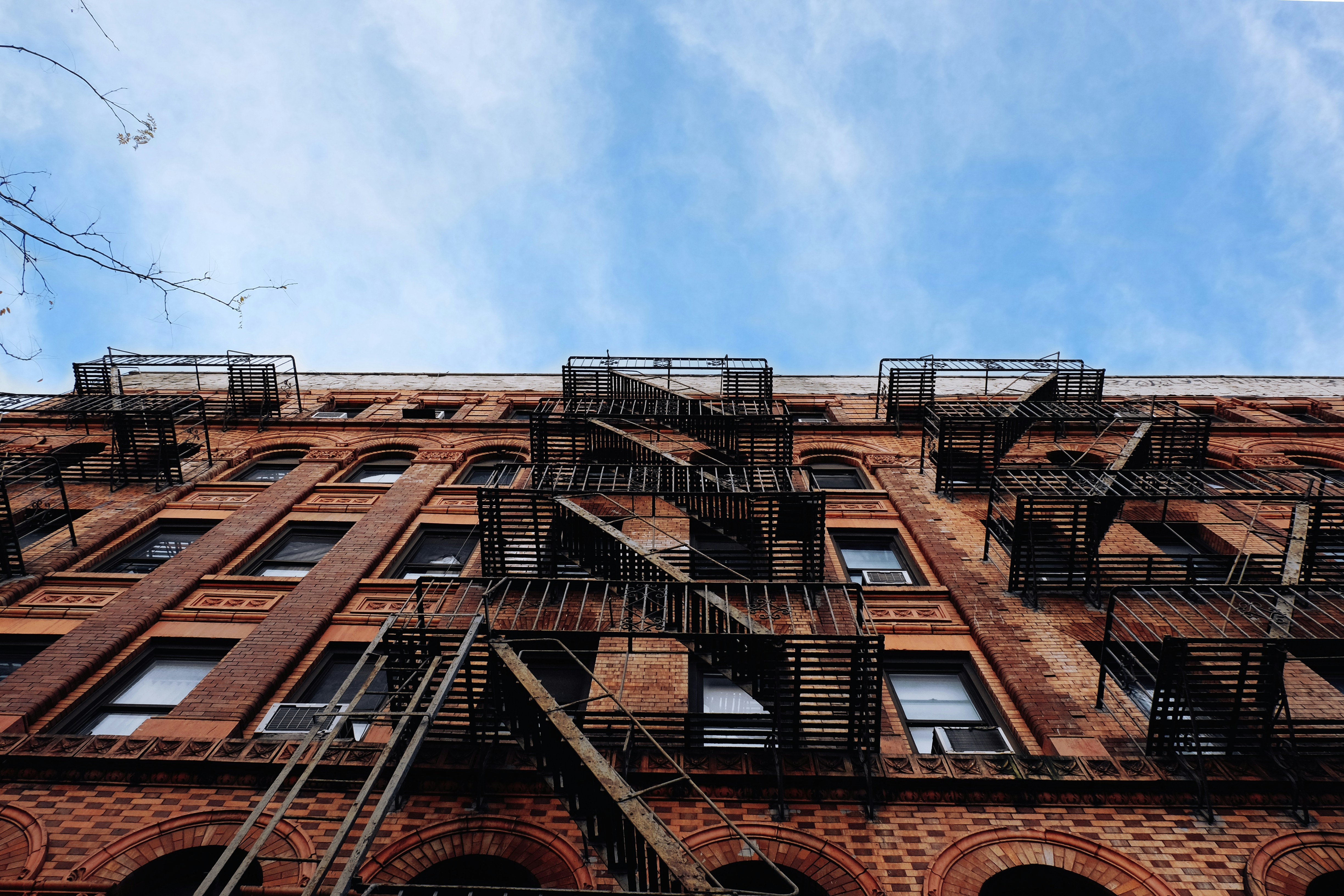 Jersey City brownstone building with fire escapes