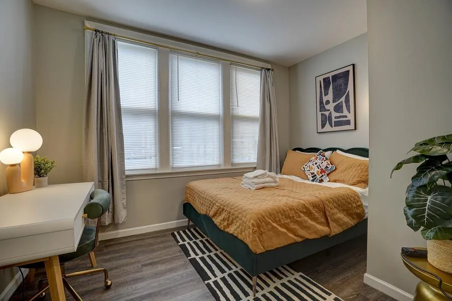 Primary bedroom teal headboard ochre bedding