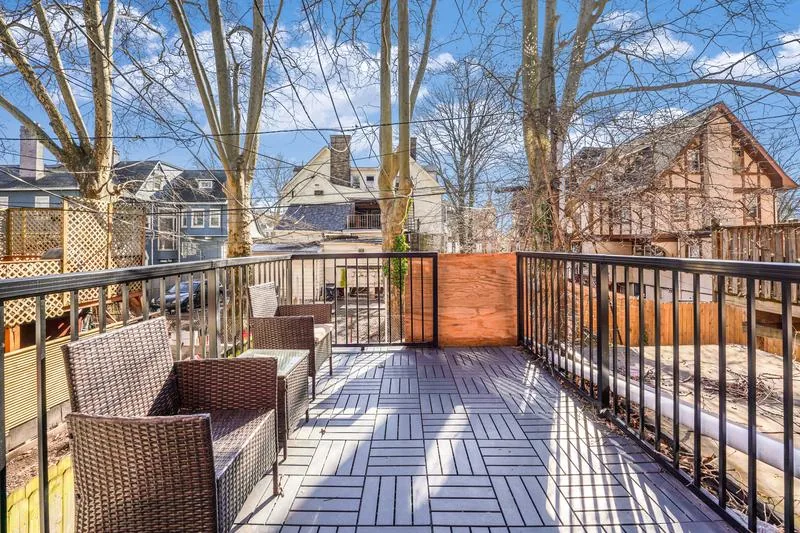 Private second-floor patio with rattan seating